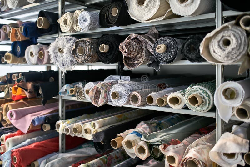 Fabric Warehouse with Many Multicolored Textile Rolls Stock Photo