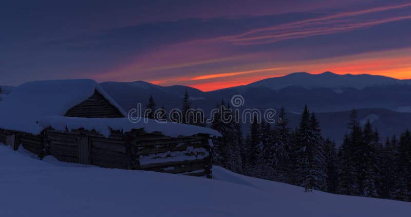 Fabulous winter sunset and hut in Carpathian Mountains