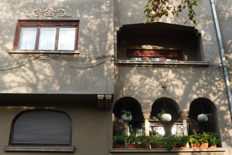 Facade of beautiful old villa, with windows and balconies, in Bucharest