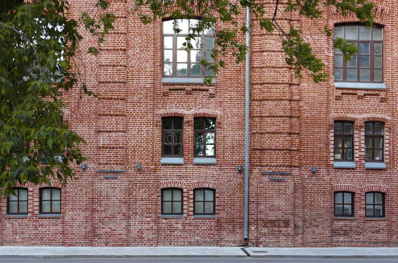 Facade of a brick building. The background city street