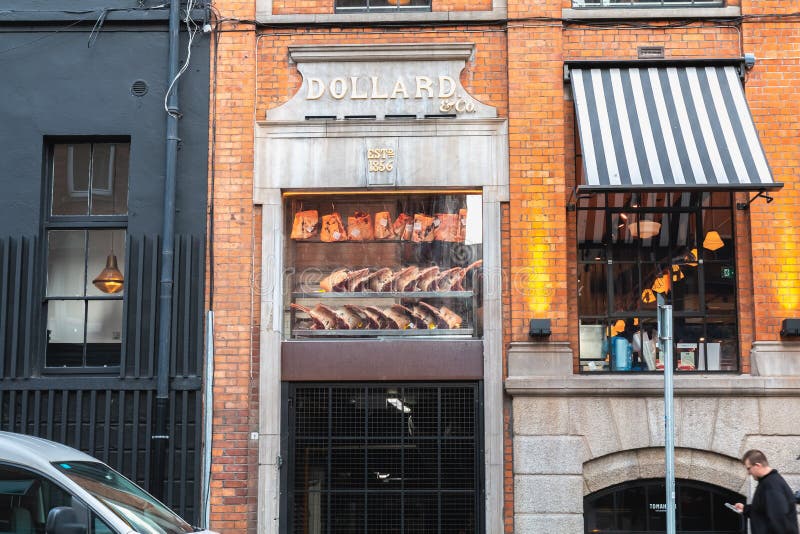 Dublin, Ireland - February 16, 2019: Facade of Dollard & Co store and restaurant in the city center on a winter day. Dublin, Ireland - February 16, 2019: Facade of Dollard & Co store and restaurant in the city center on a winter day