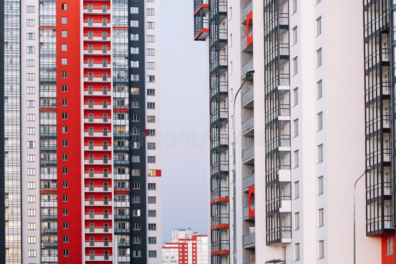 The facade of a high-rise building with red white and gray stripes. Multi-storey building against the blue sky. Background to. Illustrate the article, new royalty free stock photos The facade of a high-rise building with red white and gray stripes. Multi-storey building against the blue sky. Background to. Illustrate the article, new royalty free stock photos