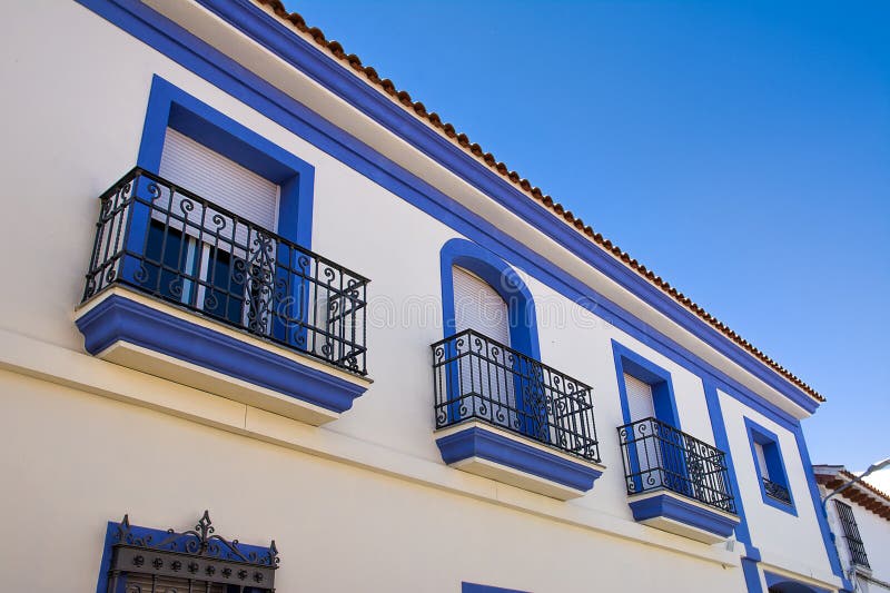 Facade of a House with Blue Framed Windows, Typical of Spain Stock
