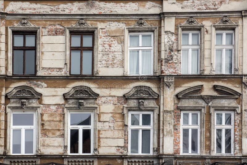 The facade of the old shabby brick house with Windows