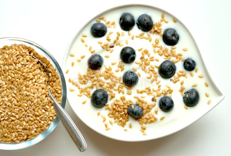 Faccia colazione con yogurt, il mirtillo ed i semi di lino