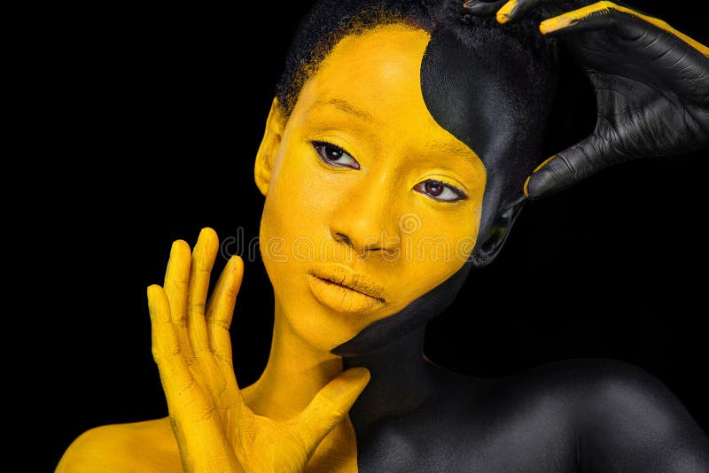 Yellow and black body paint. Woman with face art. Young girl with