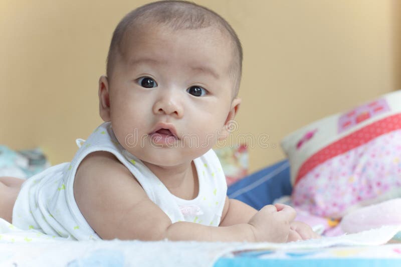 Face of baby lied on bed stock photography Face of baby lied on bed stock photography