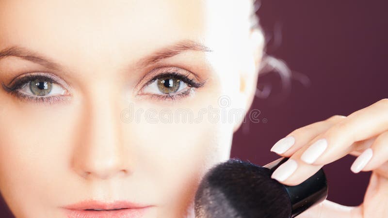 Face care and skin care, health and beauty concept, copy space. Portrait of young beautiful woman, uses powder.