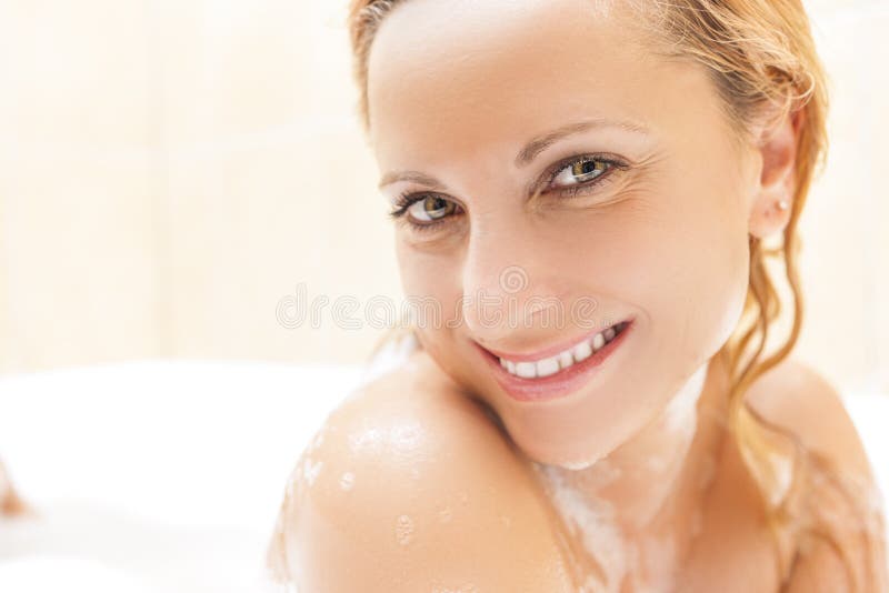 Face Closeup of Happy and Smiling Caucasian Blond woman Taking Bathtub. Positive Facial Expression.Horizontal Shot