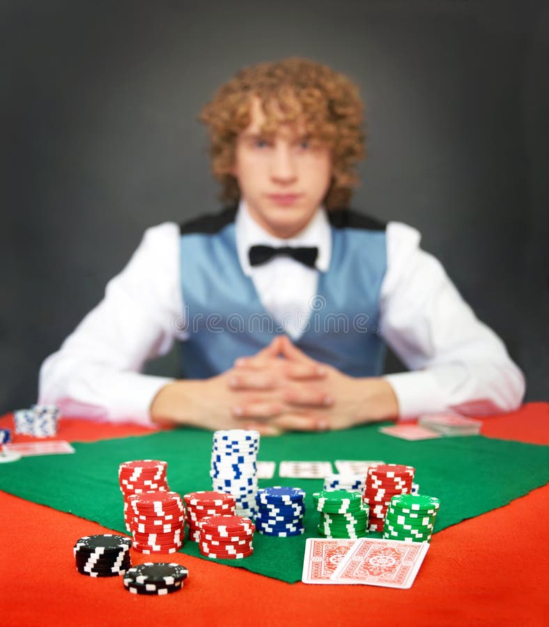 Face the dealer. A poker player facing the dealer over a stack of chips. Shallow DOF, focus on the front row of chips stock image Face the dealer. A poker player facing the dealer over a stack of chips. Shallow DOF, focus on the front row of chips stock image