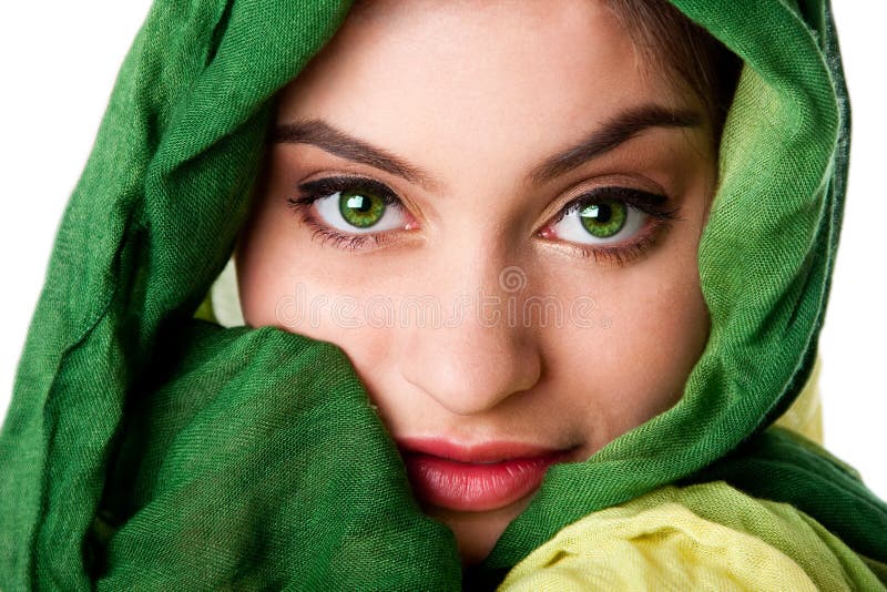 Beauty portrait of mysterious beautiful Caucasian Hispanic Latina woman face with green penetrating eyes and green fashion scarf wrapped around head, isolated. Beauty portrait of mysterious beautiful Caucasian Hispanic Latina woman face with green penetrating eyes and green fashion scarf wrapped around head, isolated.