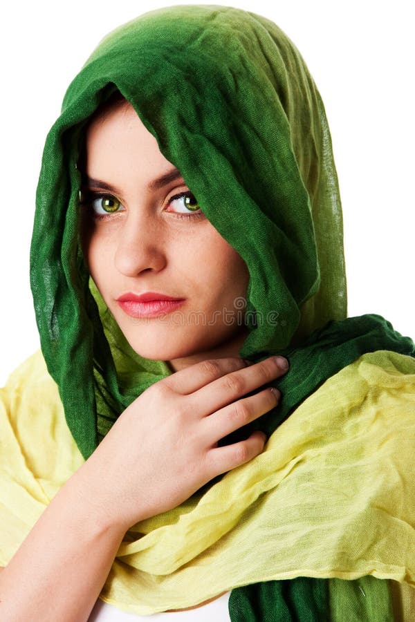 Portrait of mysterious beautiful Caucasian Middle Eastern woman face with green penetrating eyes and green fashion scarf wrapped around head, isolated. Portrait of mysterious beautiful Caucasian Middle Eastern woman face with green penetrating eyes and green fashion scarf wrapped around head, isolated.