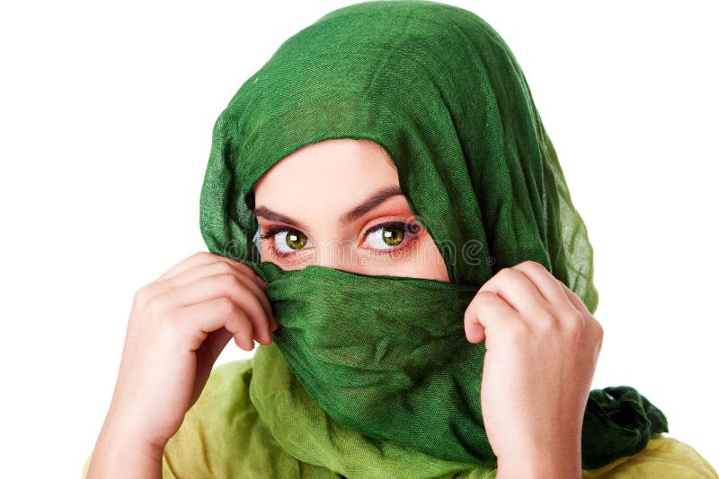 Portrait of mysterious beautiful Caucasian Hispanic Latina woman face with green penetrating eyes and holding green fashion scarf with hands in front of mouth and wrapped around head, isolated. Portrait of mysterious beautiful Caucasian Hispanic Latina woman face with green penetrating eyes and holding green fashion scarf with hands in front of mouth and wrapped around head, isolated.