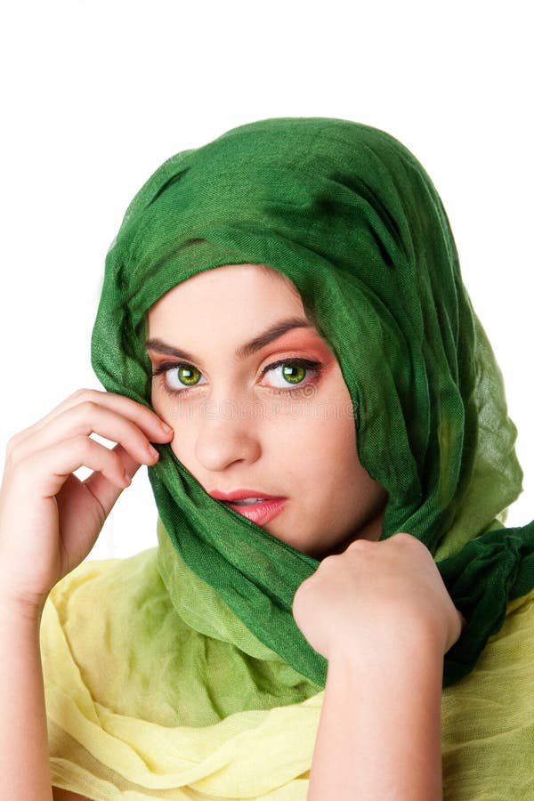 Portrait of shy mysterious beautiful Caucasian Hispanic Latina woman face with green penetrating eyes and green fashion scarf wrapped around head, isolated. Portrait of shy mysterious beautiful Caucasian Hispanic Latina woman face with green penetrating eyes and green fashion scarf wrapped around head, isolated.