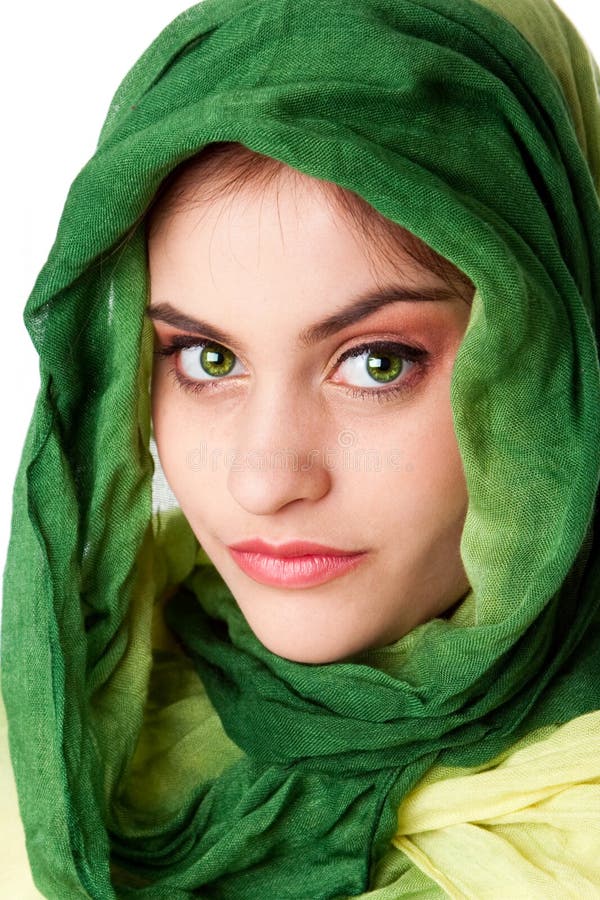 Portrait of mysterious beautiful Caucasian Hispanic Latina woman face with green penetrating eyes and green fashion scarf wrapped around head, isolated. Portrait of mysterious beautiful Caucasian Hispanic Latina woman face with green penetrating eyes and green fashion scarf wrapped around head, isolated.