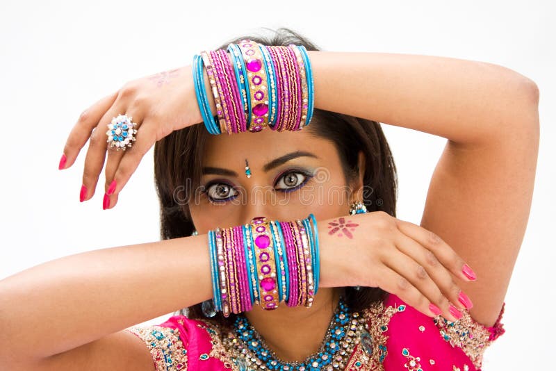 Beautiful face of a Bengali bride with her arms across her head covered with colorful bracelets, isolated. Beautiful face of a Bengali bride with her arms across her head covered with colorful bracelets, isolated