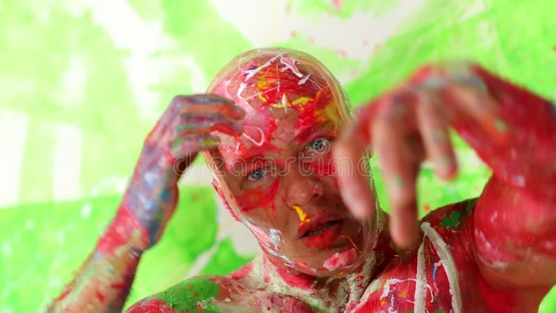 Face and hands of dancing bald man painted in stock video