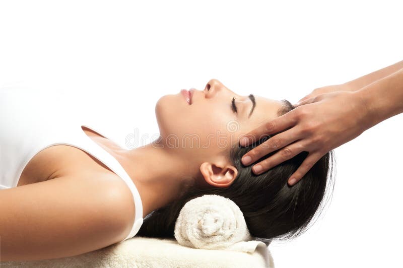 Facial massage in day spa. Her face is relaxed. The photo is isolated on white. Facial massage in day spa. Her face is relaxed. The photo is isolated on white.