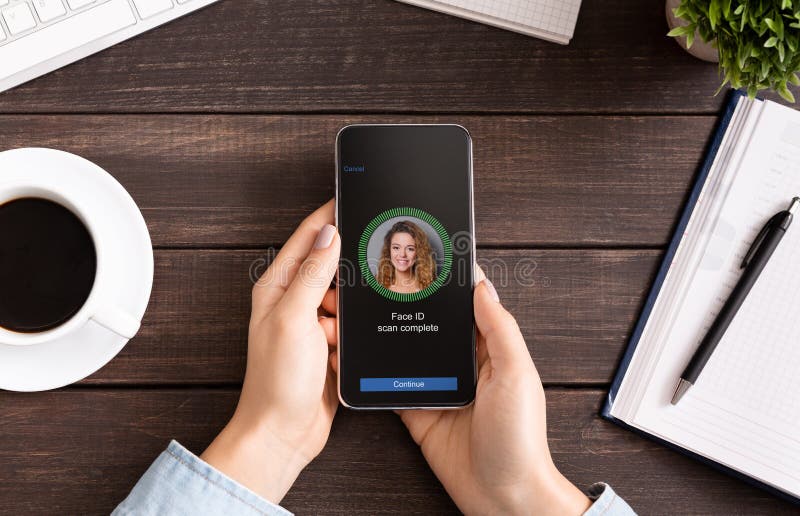 Girl Scanning Face with Facial Recognition System on Smartphone Stock