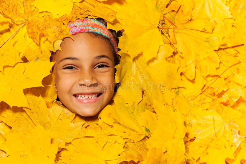 Face of a Little African Girl in Autumn Leaves Stock Image - Image of ...