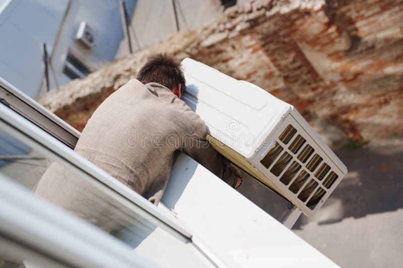 Without a Face. a Man Installs an External Air Conditioner. Dangerous