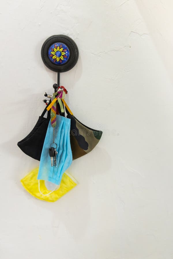 Face masks of various types hanging with a bunch of keys royalty free stock images