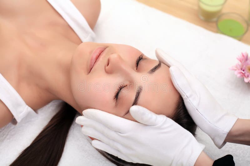 Face massage. Spa skin and body care. Close-up of young woman ge stock photos Face massage. Spa skin and body care. Close-up of young woman ge stock photos