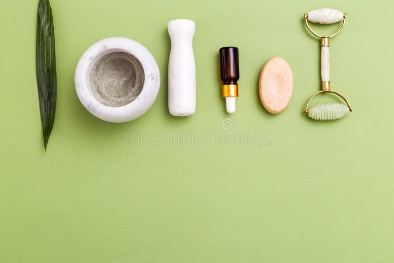 Face Roller and Skin Care Products on Green Background. Copy Space. Flat  Lay Stock Photo - Image of beauty, cosmetic: 161011652