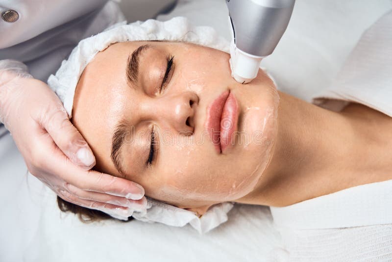 Face Skin Care. Close-up Of Woman Getting Facial Hydro Microdermabrasion Peeling Treatment At Cosmetic Beauty Spa Clinic