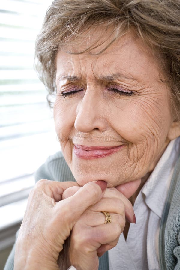 Face of upset elderly woman with eyes closed royalty free stock image