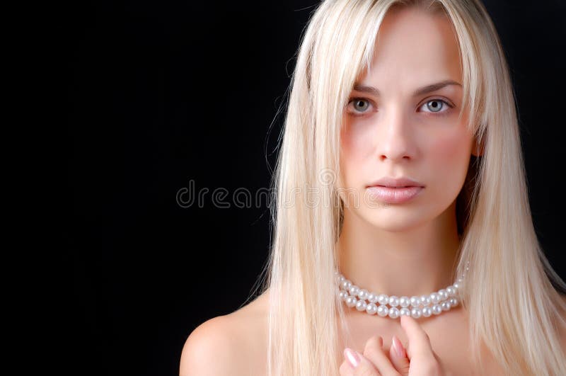 Face of woman and pearl necklace
