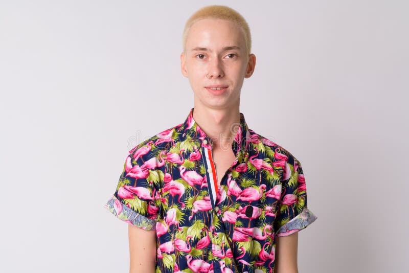 Studio shot of young handsome androgynous tourist man in bohemian shirt against white background. Studio shot of young handsome androgynous tourist man in bohemian shirt against white background