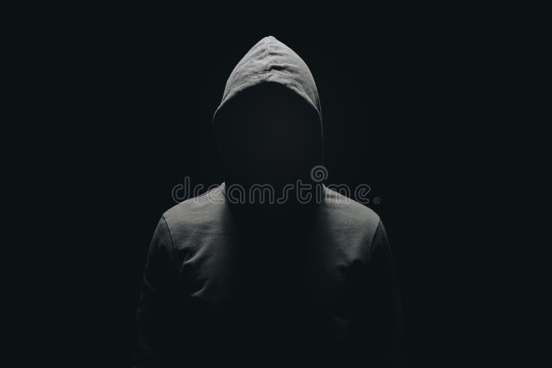 faceless man in hoodie standing