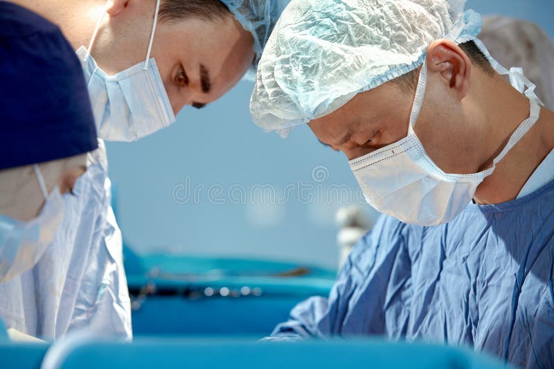 Faces of Surgeons Closeup during a Complex and Intense Operation