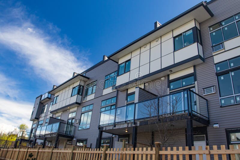 External facade of a row of colorful modern urban townhouses. brand new houses just after construction on real estate market. External facade of a row of colorful modern urban townhouses. brand new houses just after construction on real estate market