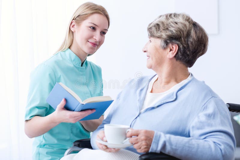 Image of professional caregiver and elderly cheerfulness patient. Image of professional caregiver and elderly cheerfulness patient