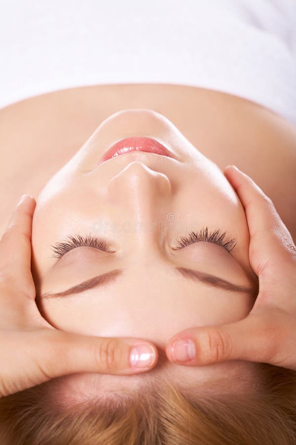 Face of calm female during procedure of facial massage