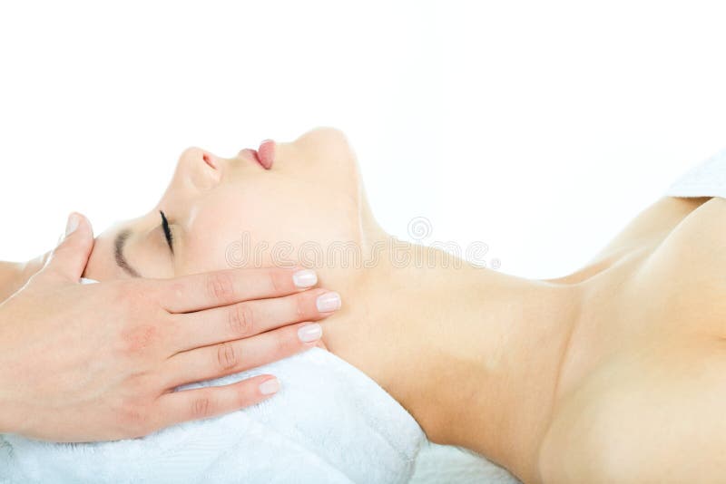 Beautiful woman is getting a facial massage in the spa salon