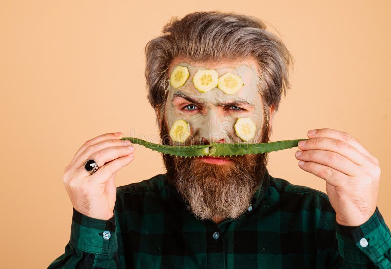 Facial Treatment. Funny Bearded Man with Clay Facial Mask in Beauty Spa ...