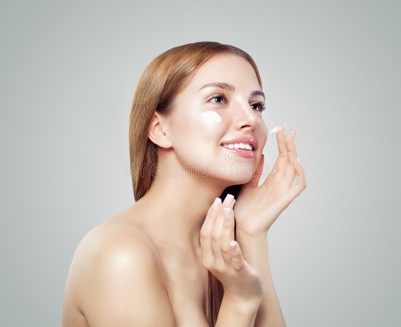 Facial Treatment And Skin Care Portrait Young Woman Applying Cream On Healthy Skin Stock Image