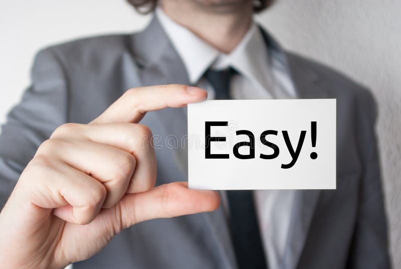 Easy. Businessman in suit with a black tie showing or holding business card. Easy. Businessman in suit with a black tie showing or holding business card