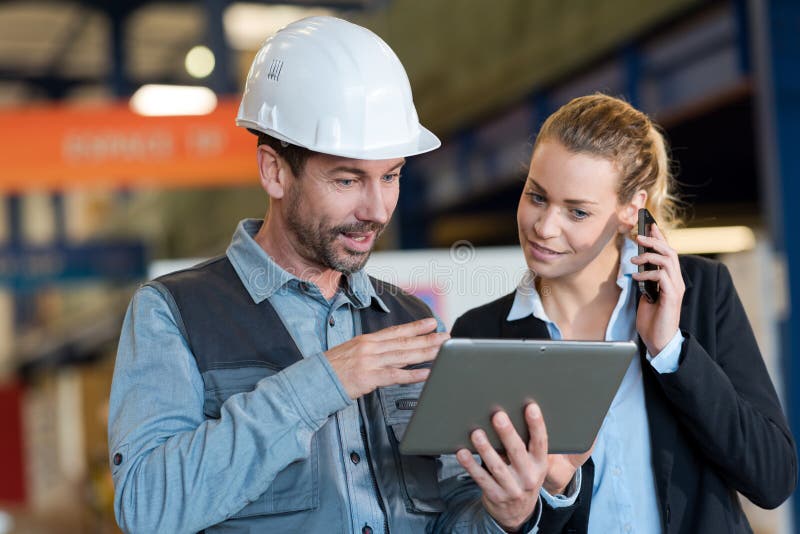 Factory manager showing huge order on website stock photography