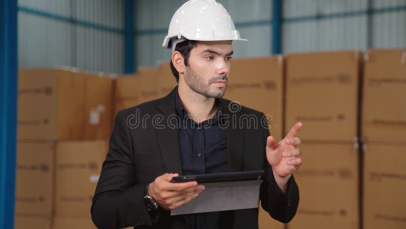 Factory manager using tablet computer in warehouse or factory . Industry and supply chain management concept .