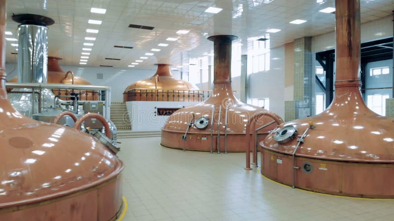 Factory room with big tanks, brewing beer.