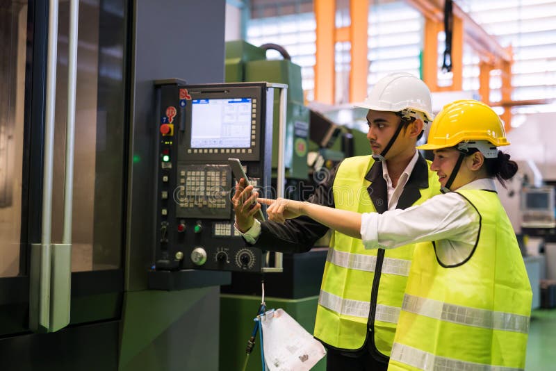 Factory workers check productivity in tablet royalty free stock images Factory workers check productivity in tablet royalty free stock images