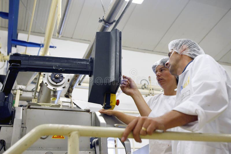 Factory workers operating the control panel stock photography