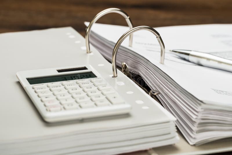 Close-up Of Invoice With Calculator And Pen On Desk. Close-up Of Invoice With Calculator And Pen On Desk