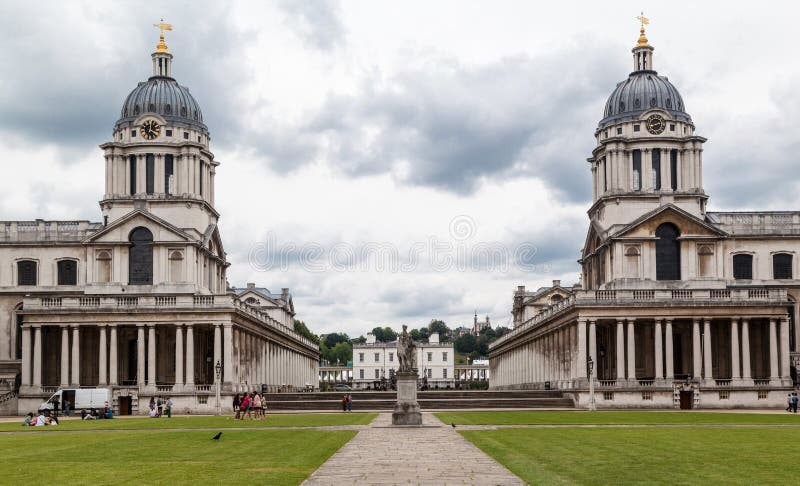 The facade of the two clock towers with domes and the buildings with doric collonade of the Royal Naval College in the Greenwich university, England. The facade of the two clock towers with domes and the buildings with doric collonade of the Royal Naval College in the Greenwich university, England.