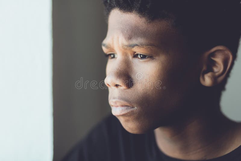 Faded retro portrait of a worried African boy