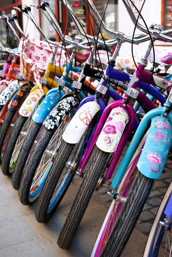 Bicycles row, custom bikes with colorful various patterns: flowers, flower power. Bicycles row, custom bikes with colorful various patterns: flowers, flower power.